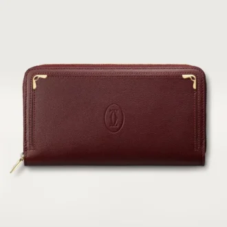 Portefeuille international zippé, Must De Cartier – Cuir de veau bordeaux, finition dorée – Cartier